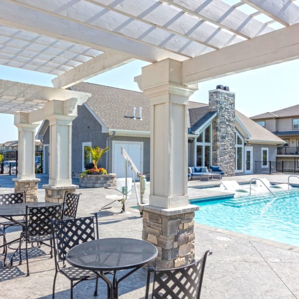 Swimming pool with patio table and chairs at Prairie Pines in Shawnee, Kansas
