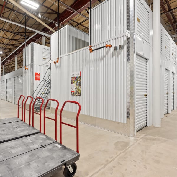 Indoor units with moving dollies nearby at StorQuest Self Storage in Englewood, Colorado