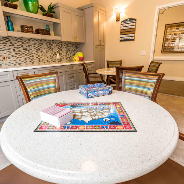 Round table with board games at Pacifica Senior Living Mission Villa in Daly City, California