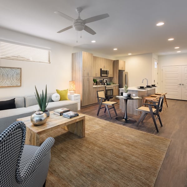 Modern living room with luxury wood-style flooring at Sanctuary on 51st in Laveen, Arizona