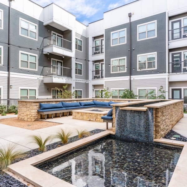 Outdoor courtyard area with fireplace at The Everett at Ally Village in Midland, Texas