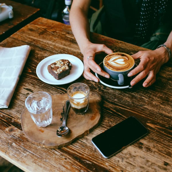 A resident enjoys coffee and pastries near Aster, Long Beach, California