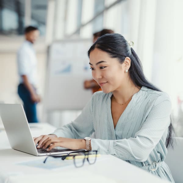 Member working on her laptop at Symphony Property Management in Buffalo, New York