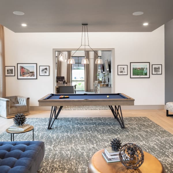 Resident recreation area with large pool table and sofa at Bellrock Market Station in Katy, Texas