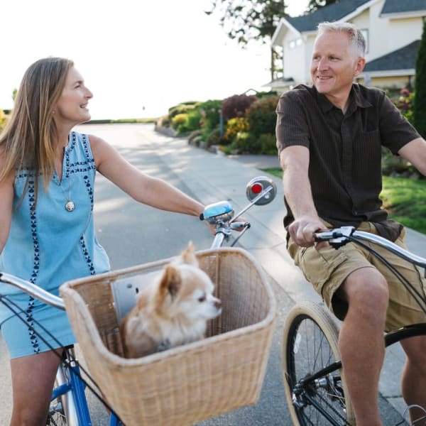 Residents riding their bike through the neighborhood near The Residences at Monterra Commons in Cooper City, Florida
