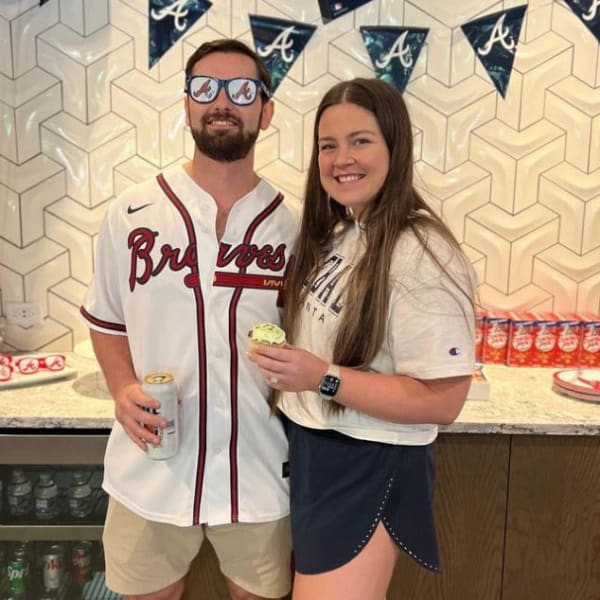 Couple wearing baseball attire at Revel Ballpark in Smyrna