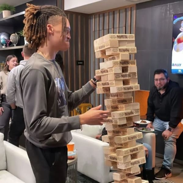 Person playing giant Jenga at Revel Ballpark in Smyrna