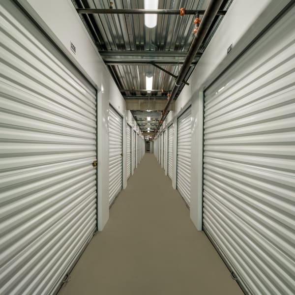 Indoor storage units with bright doors at StorQuest Self Storage in Santa Clarita, California