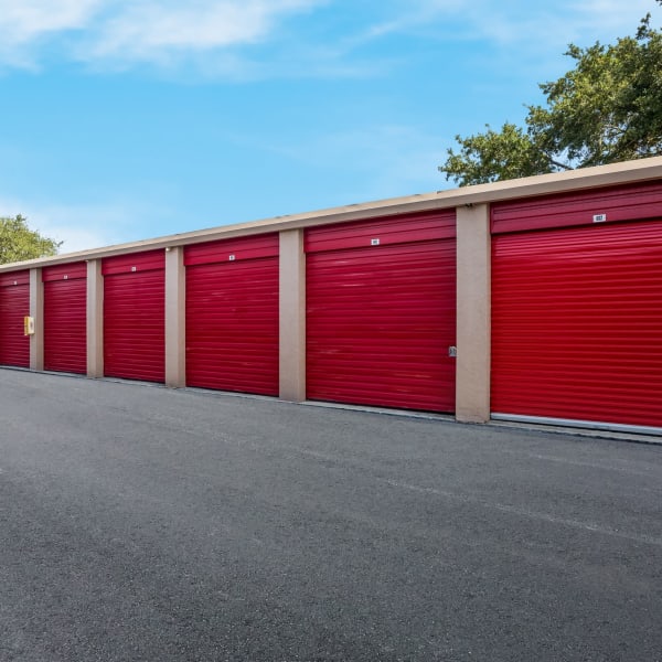 Outdoor storage units with red doors at StorQuest Self Storage in Sarasota, Florida