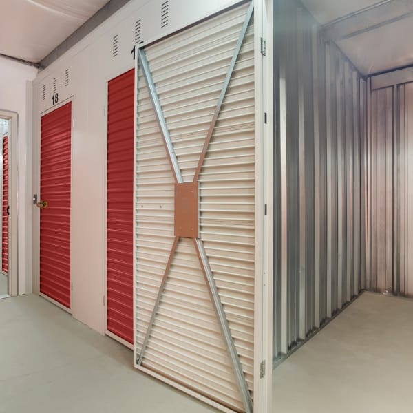 Indoor storage units with red doors at StorQuest Self Storage in Odessa, Florida