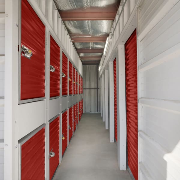Red doors on indoor units and lockers at StorQuest Economy Self Storage in Champaign, Illinois