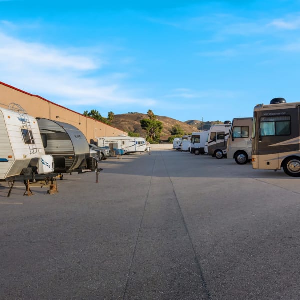 RVs, boats, cars, and trailers parked at StorQuest Self Storage in Riverside, California