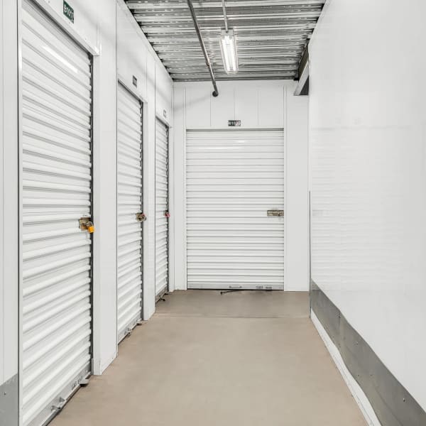 Indoor storage units with bright doors at StorQuest Self Storage in Stockton, California