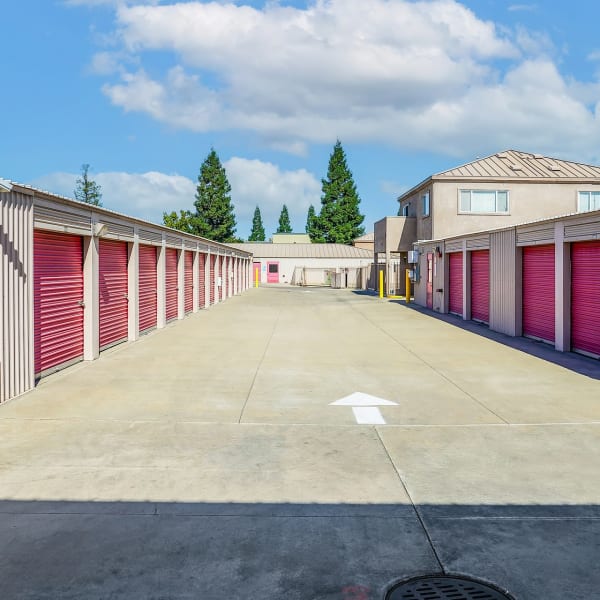 Outdoor storage units with red doors at StorQuest Self Storage in Stockton, California