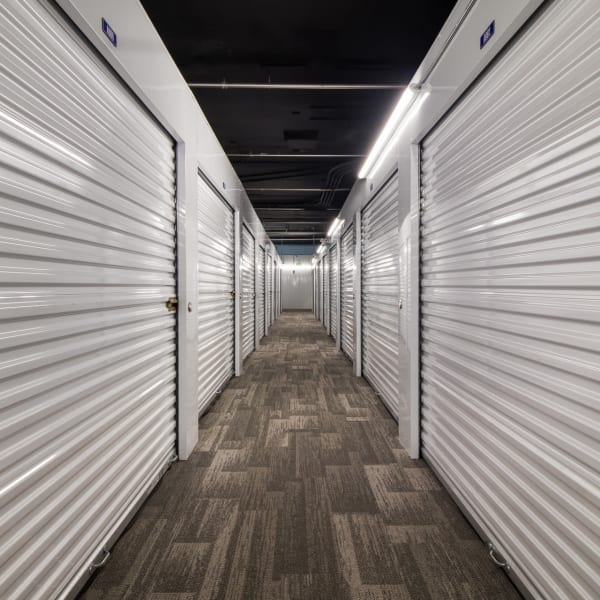 Indoor storage units with white doors at StorQuest Self Storage in Long Beach, California