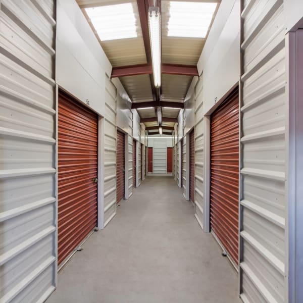 Indoor storage units with red doors at StorQuest Self Storage in Centennial, Colorado