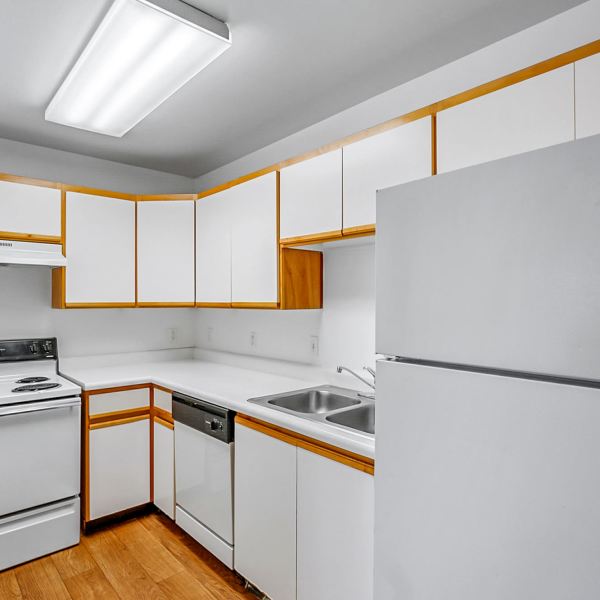 Kitchen with white cabinets at Mayflower Harbor at Pilgrims Landing in Lehi, Utah