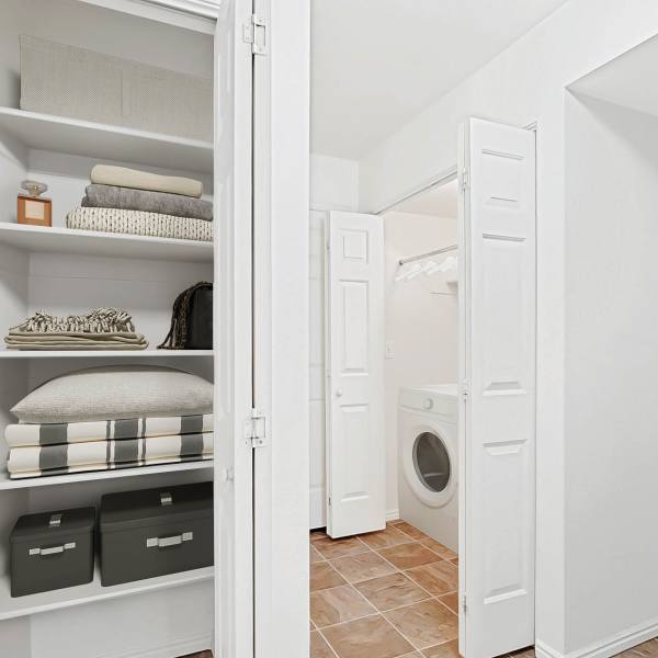In-unit washer and dryer with extra linen storage at Rose Cove Apartment Homes in Farmington, Utah