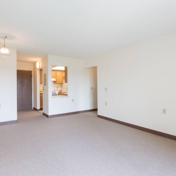 Living room and pass-through to the kitchen of a model apartment at North Port Village in Port Huron, Michigan