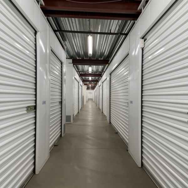 Indoor storage units with white doors at StorQuest Self Storage in Long Beach, California