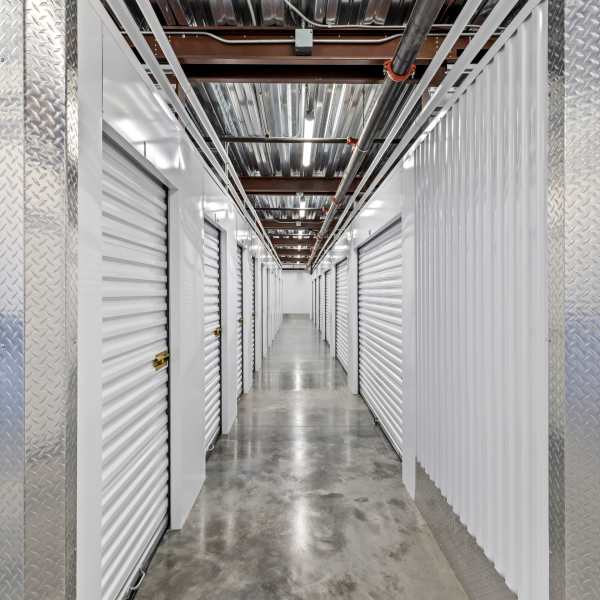 Indoor storage units with bright doors at StorQuest Self Storage in Vista, California