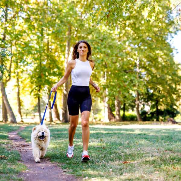 Woman walking her dog at The Abbey at Jones Road in Houston, Texas