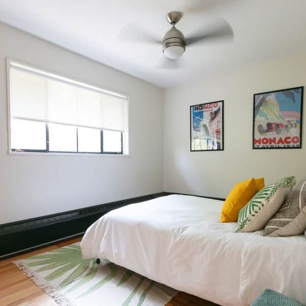 Natural light coming into a bedroom with ceiling fan at Detroit Living in Detroit, 