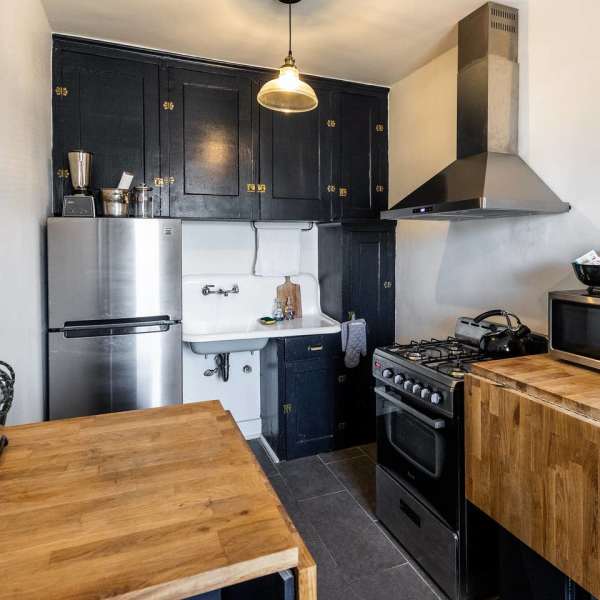 Kitchen with stainless-steel refrigerator at Detroit Living in Detroit, Michigan