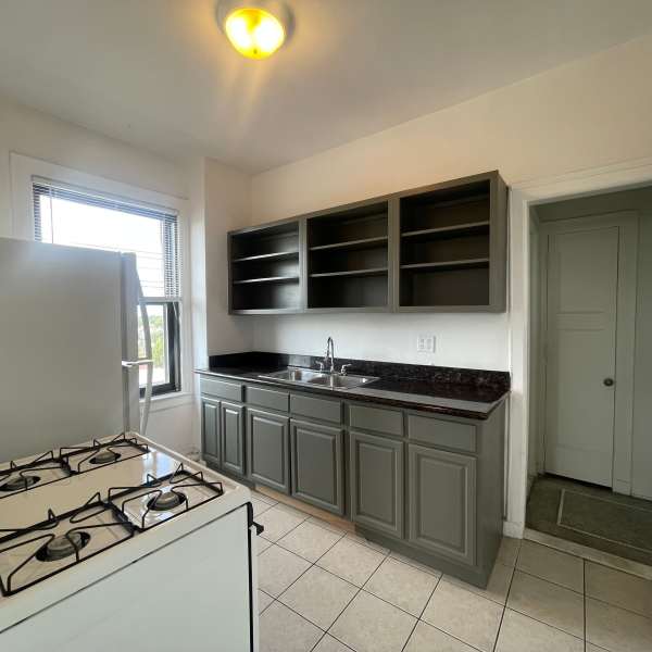 Kitchen with cabinets at Detroit Living in Detroit, Michigan