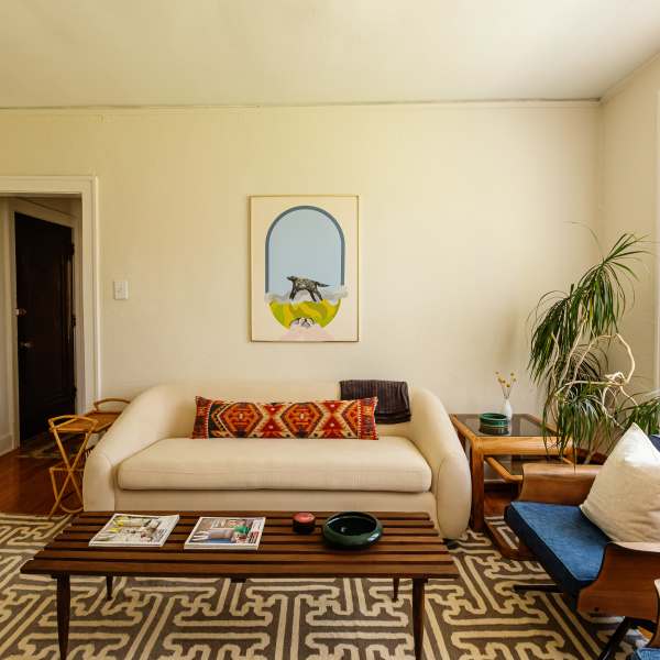 Living room with couch and plants at Detroit Living in Detroit, Michigan