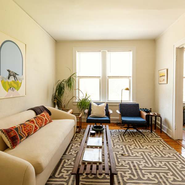 Model living space with large windows at Detroit Living in Detroit, Michigan