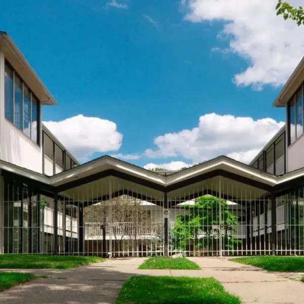 Grassy walking path surrounding building at Detroit Living in Detroit, Michigan