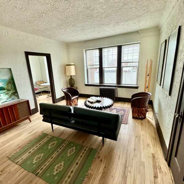 Living room with couch and window at Detroit Living in Detroit, Michigan