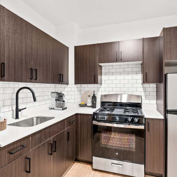 Kitchen with tan colored cabinetry at Detroit Living in Detroit,Michigan