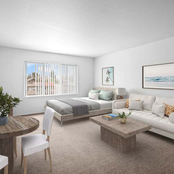 Model living and bedroom space of studio with staged furniture at Piedmont in Oakland, California