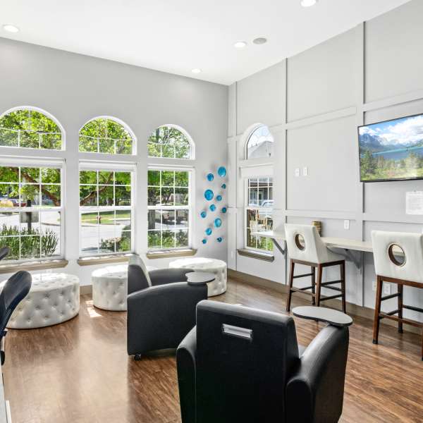 Clubhouse with large windows, several black office chairs and small table in the center at Fox Ridge in Longmont, Colorado