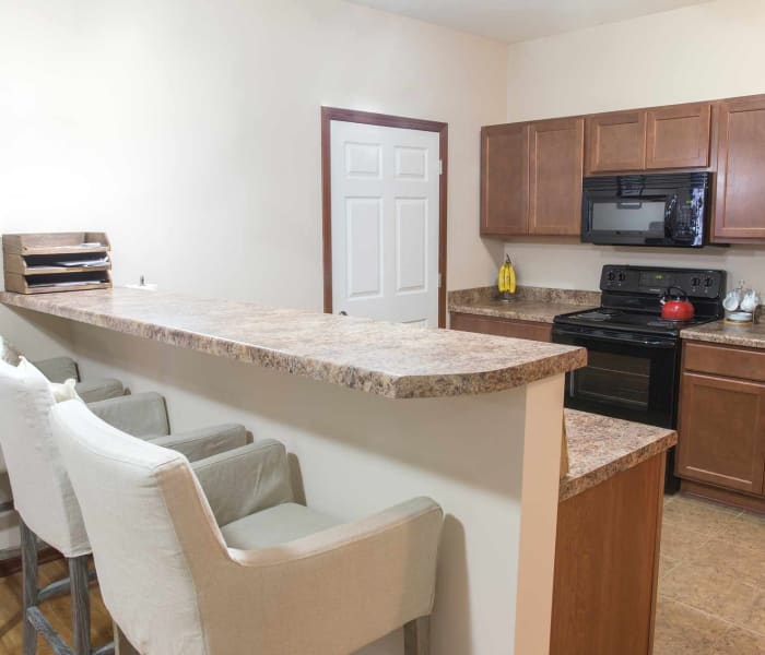 Apartment kitchen with bar seating at Woodland Reserve in Ankeny, Iowa