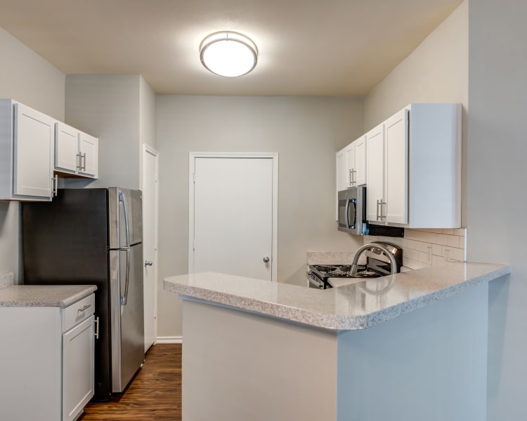 Forum at Grand Prairie offers a naturally well-lit living room in Grand Prairie, Texas