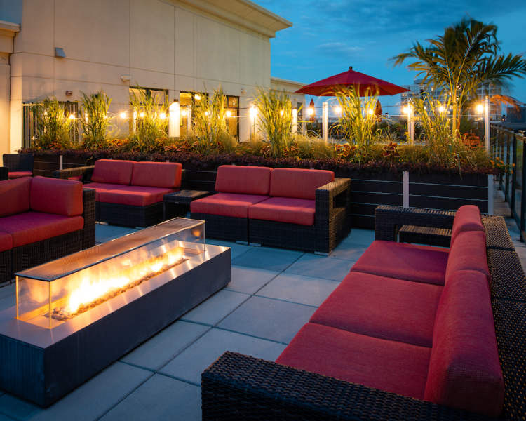 Nighttime view of outdoor fire and patio seating at The Eden in Baltimore, Maryland