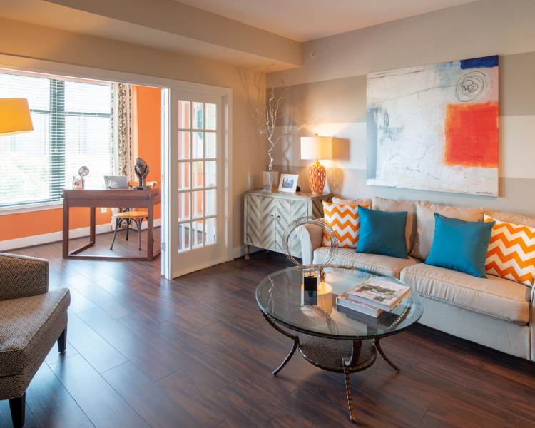 Living space with wood-style flooring at The Eden in Baltimore, Maryland