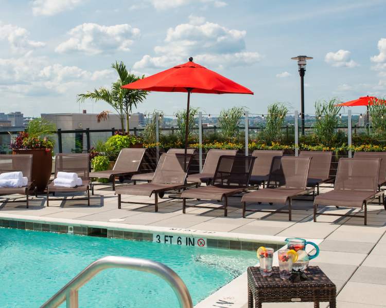 Lounge poolside in a lounge chair at The Eden in Baltimore, Maryland