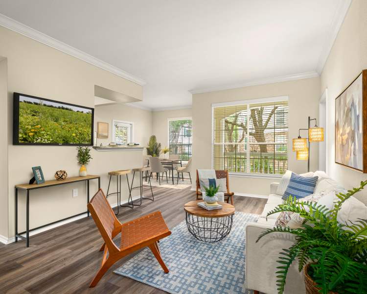 Living room with view of dining room at The Lodge at Shavano Park