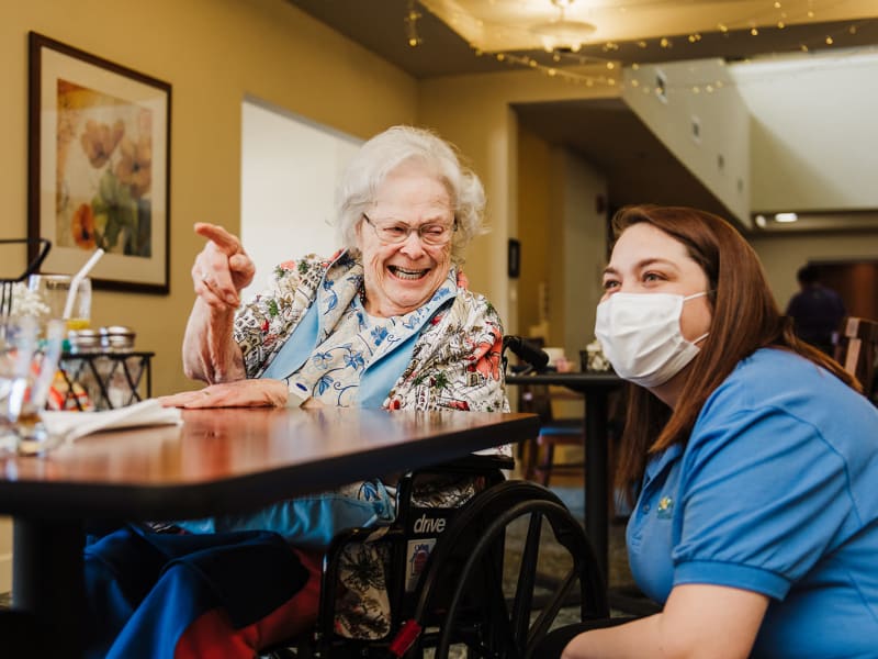 Resident gesturing for a caretaker at English Meadows Laurens Campus in Laurens, South Carolina