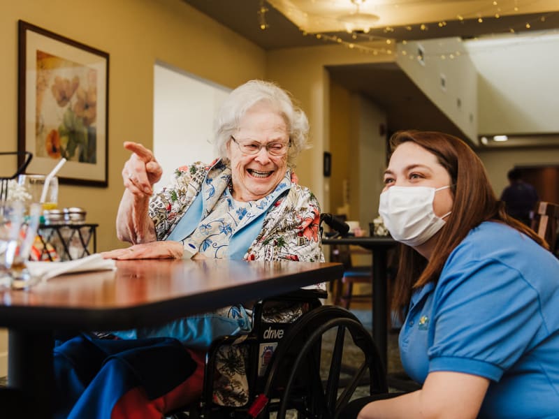 Resident gesturing for a caretaker at English Meadows Kathwood Campus in Columbia, South Carolina
