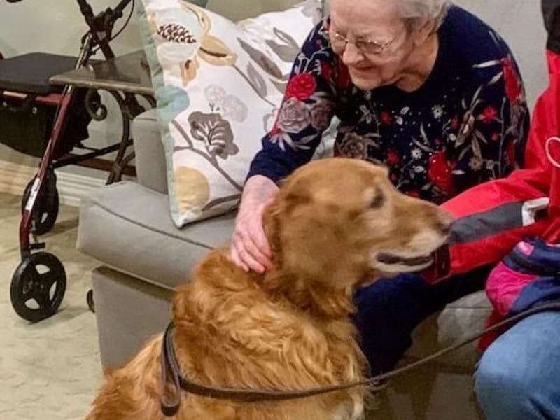 Resident petting dog  at Shawnee Memory Care in Shawnee, Oklahoma