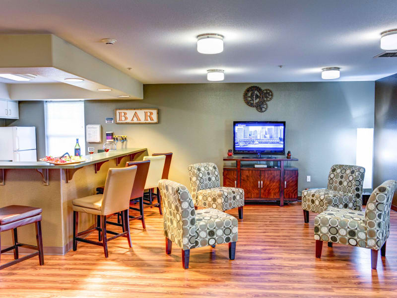 Community room with a bar and TV at Lone Oak Assisted Living in Eugene, Oregon