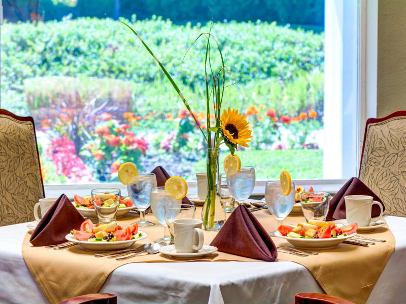 Inviting table set with fresh salads in the dining room at The Suites Assisted Living and Memory Care in Grants Pass, Oregon