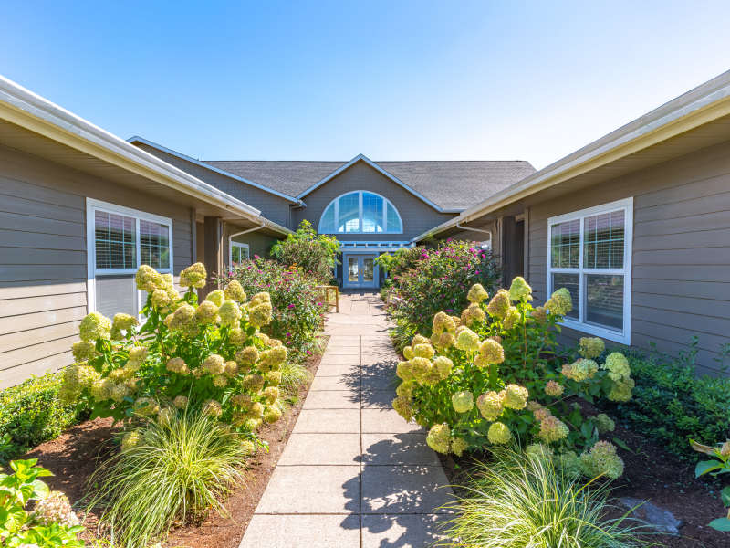 Walkway with beautiful plants at Evergreen Memory Care in Eugene, Oregon