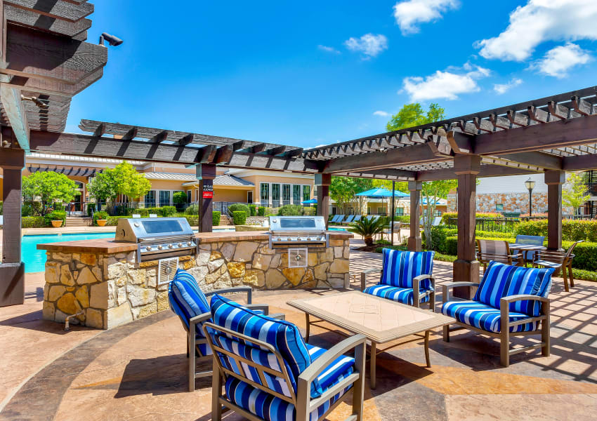 BBQ area by the pool at Onion Creek Luxury Apartments in Austin, Texas