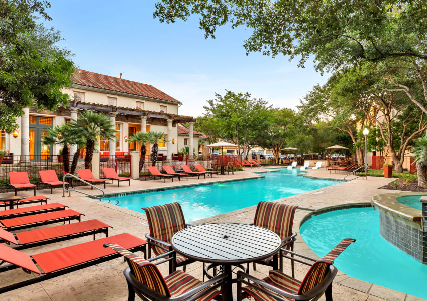 Lounge chairs by the pool at Sedona Ranch Apartments in San Antonio, Texas